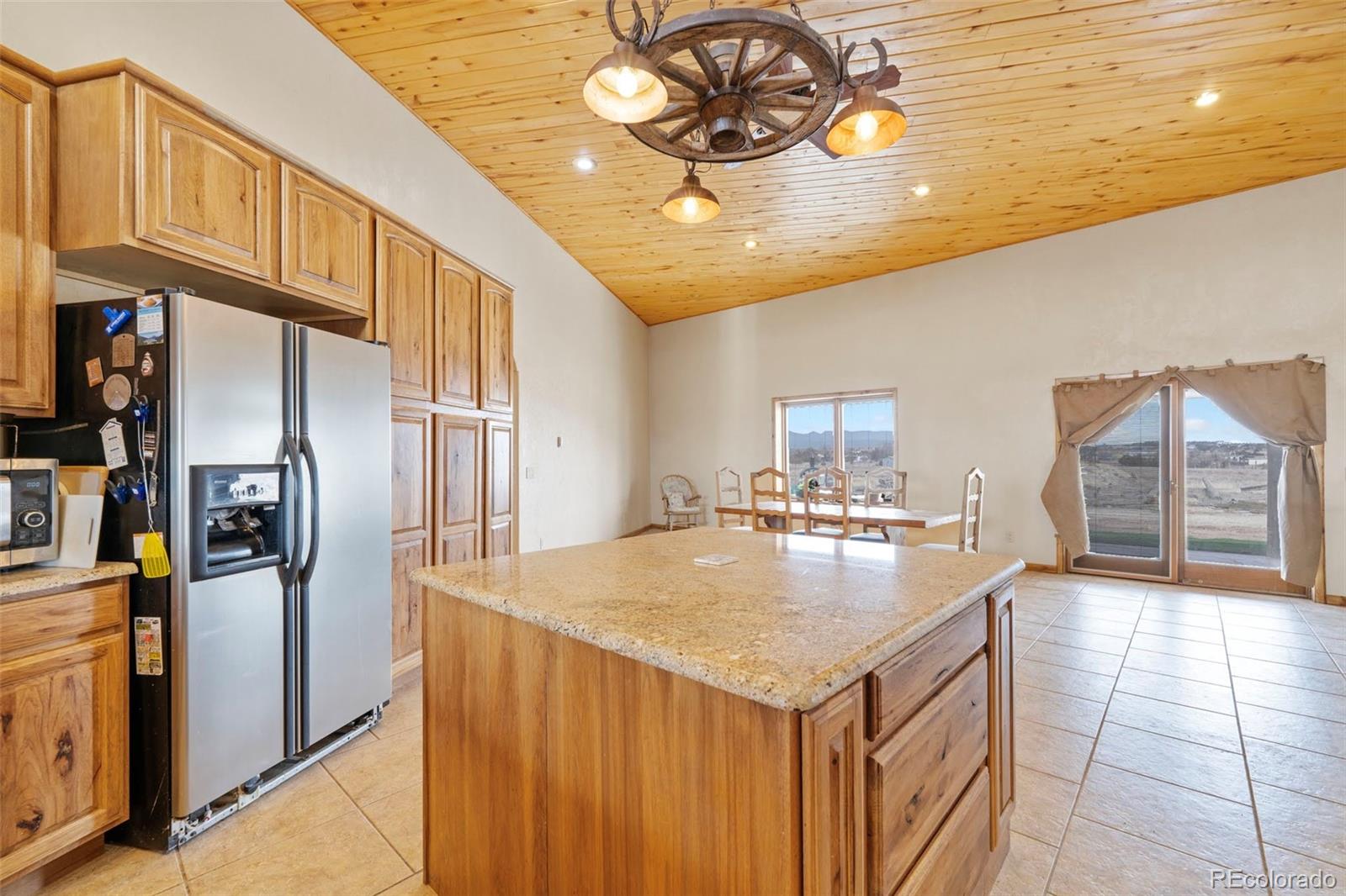 988 P Street Penrose, CO 81240 - Photo 6 of 48 a kitchen with stainless steel appliances granite countertop a sink a refrigerator and a stove