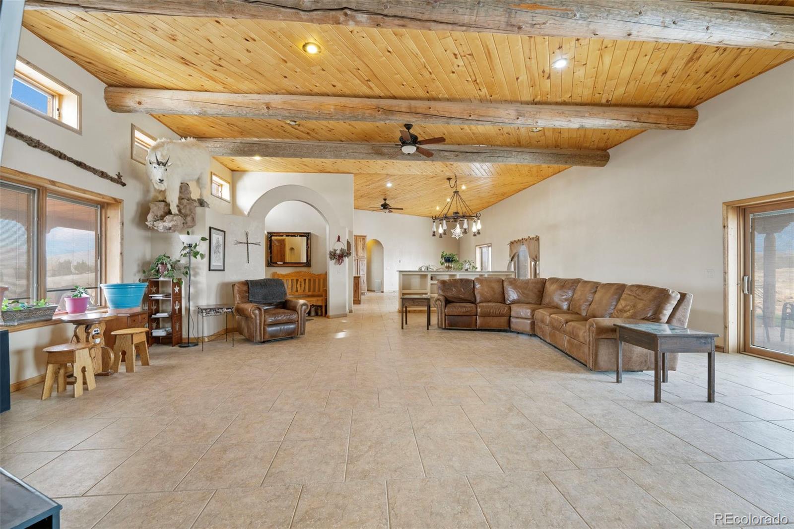 988 P Street Penrose, CO 81240 - Photo 7 of 48 a living room with furniture and a chandelier