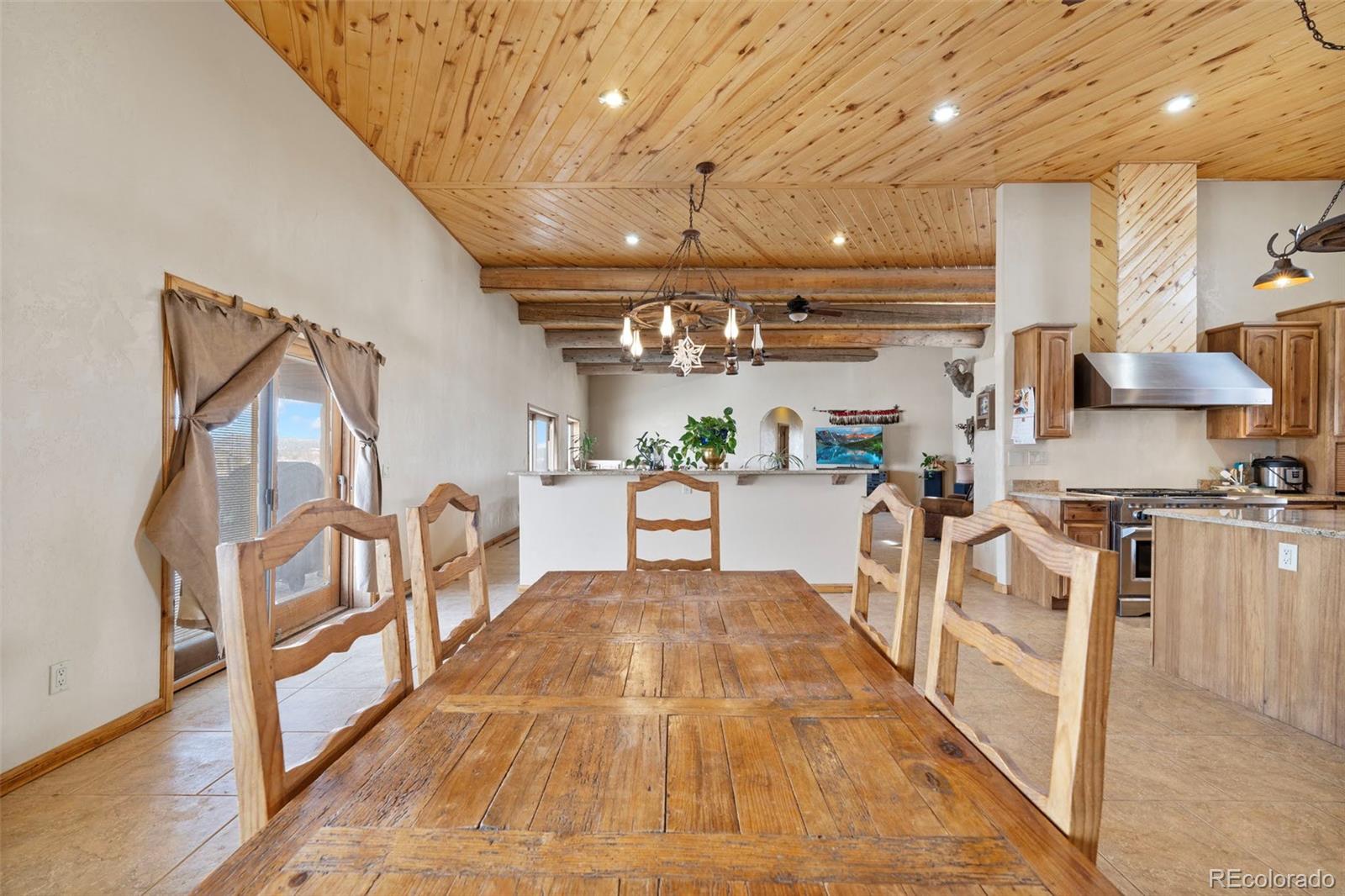 988 P Street Penrose, CO 81240 - Photo 10 of 48 a view of a kitchen with furniture and wooden floor