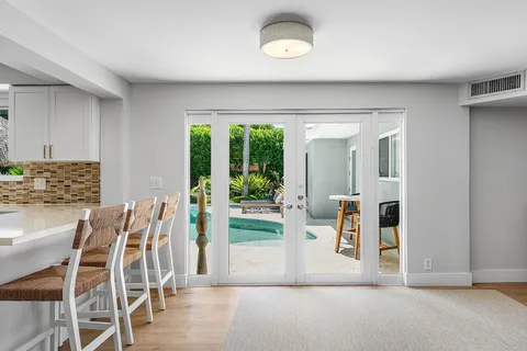 a view of dining room with furniture and floor to ceiling window