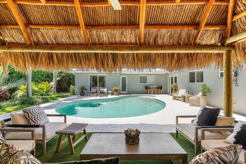 a view of a chairs and table in a backyard