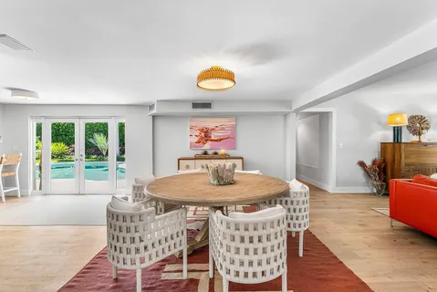 a view of a dining room with furniture wooden floor and chandelier