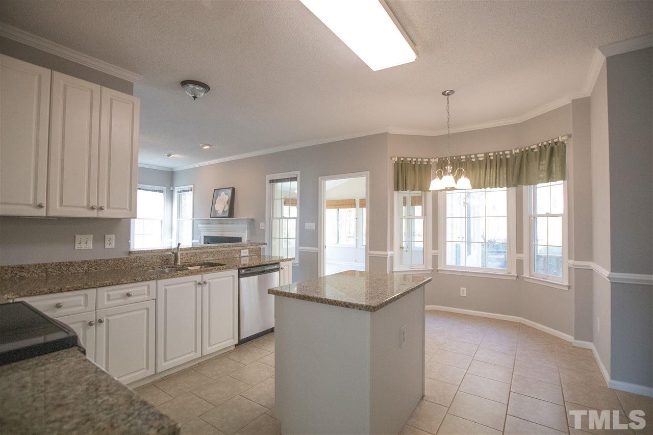 5212 Halcott Court Raleigh, NC 27613 - Photo 22 of 27 a large kitchen with granite countertop a sink and a counter top space