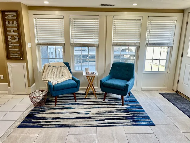a living room with furniture and floor to ceiling windows