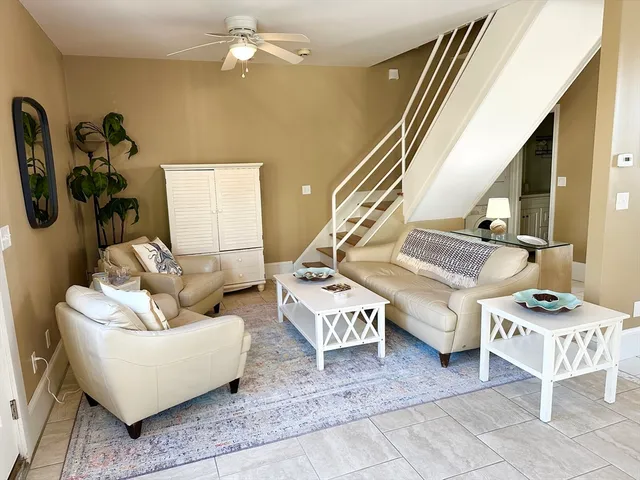 a living room with furniture and a potted plant