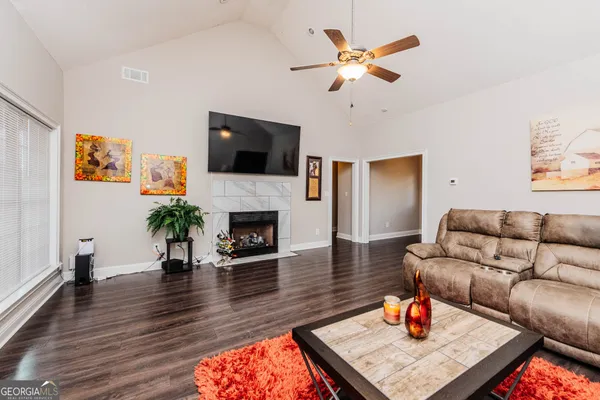 a living room with furniture fireplace and a flat screen tv
