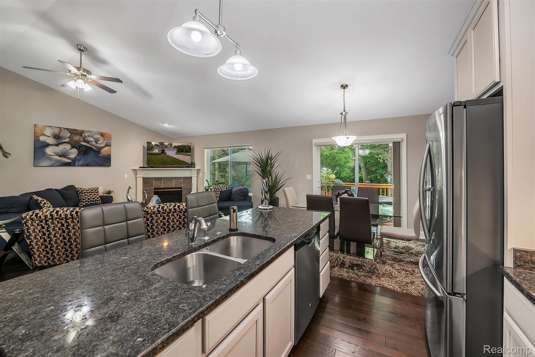 147 Sedum Road Howell, MI 48843 - Photo 5 of 34 Enjoy the Cozy Gas Fireplace and View of Treelined Backyard