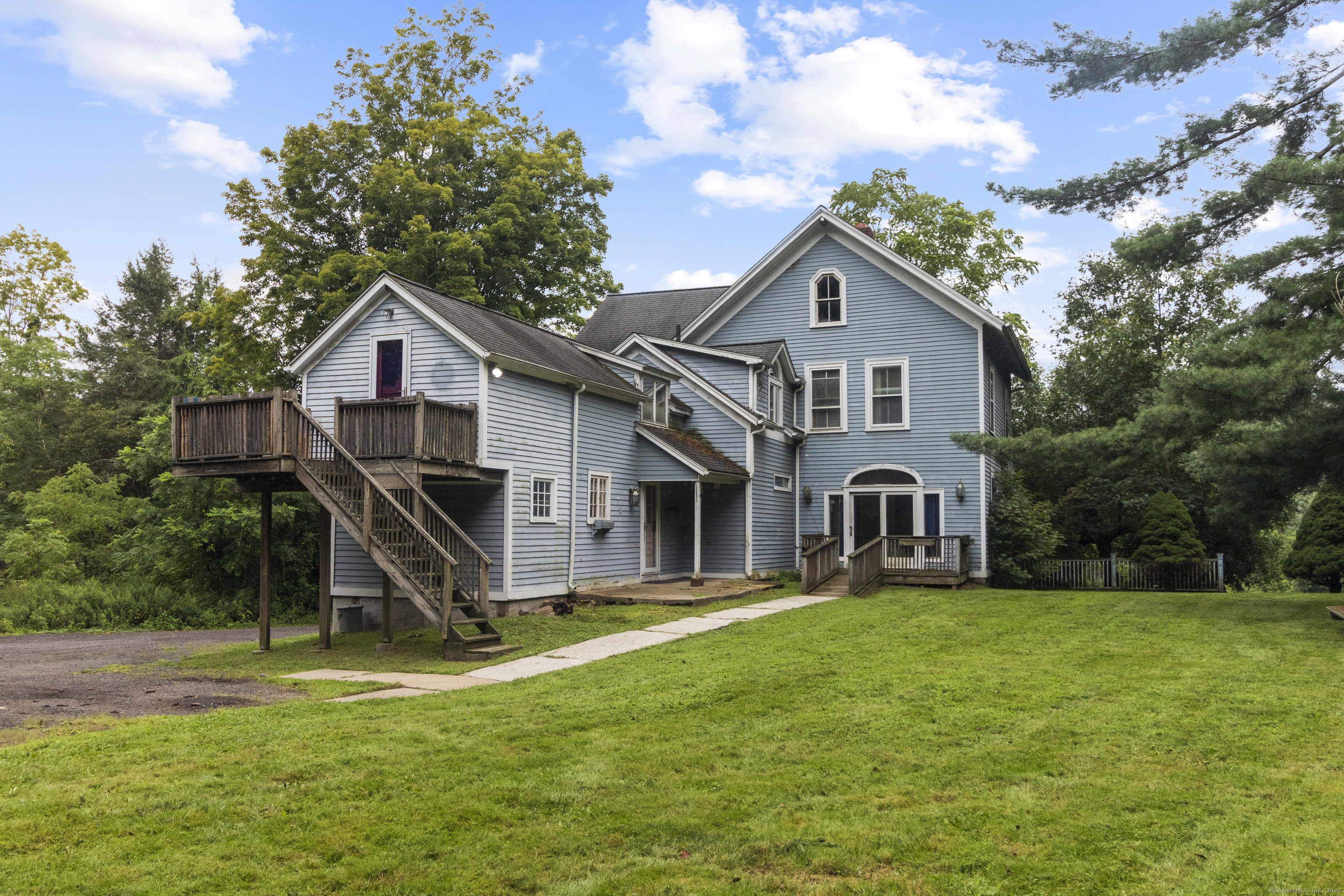 a front view of a house with yard and green space