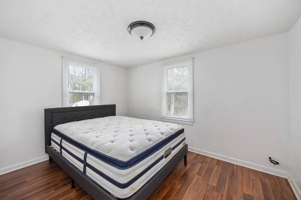 a bed sitting in a bedroom next to a window
