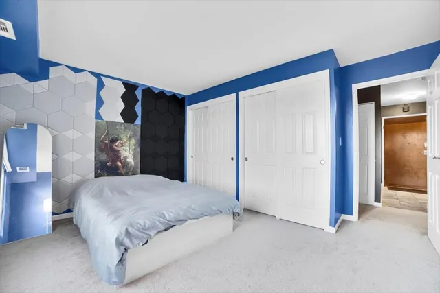 a spacious bedroom with a bed and a cabinets