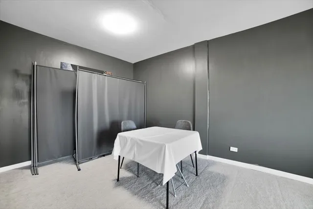 a view of a room with a table and chairs