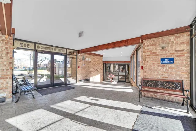 a living room with furniture and large windows