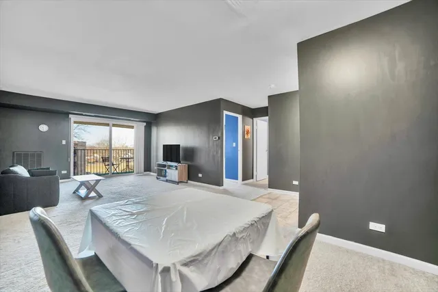 a large bedroom with a bed and large mirror