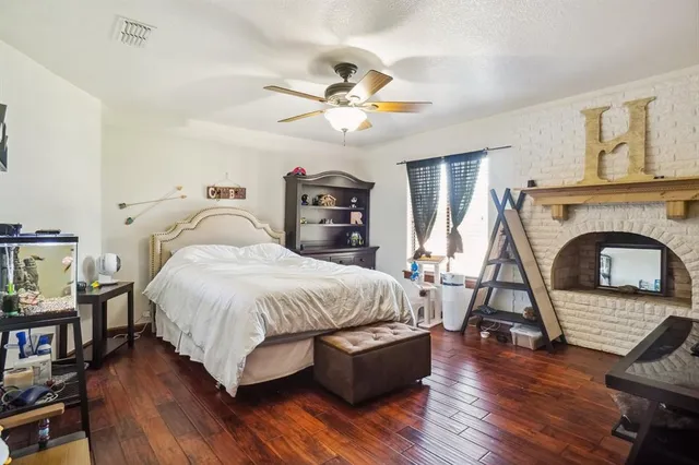 a spacious bedroom with a bed and a fireplace