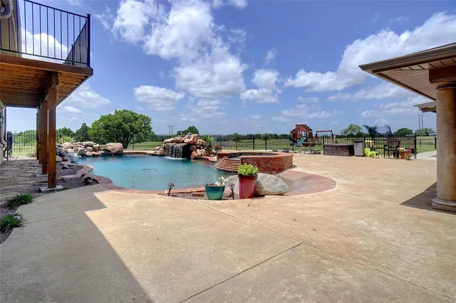 swimming pool view with a seating space
