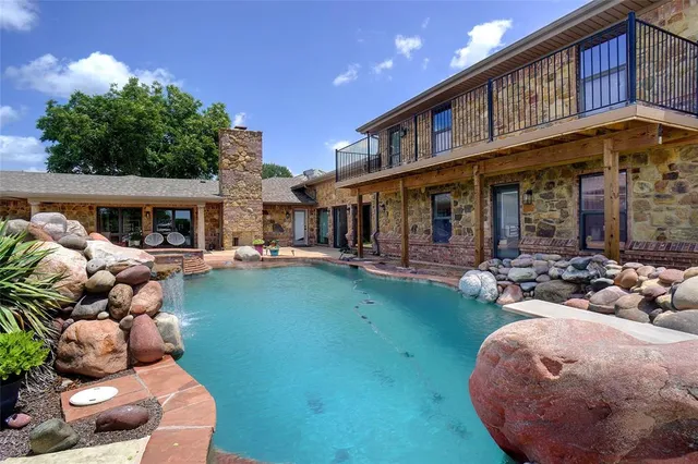 a view of a house with backyard porch and furniture