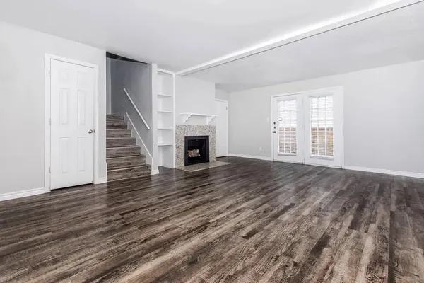 wooden floor in an empty room with a fireplace