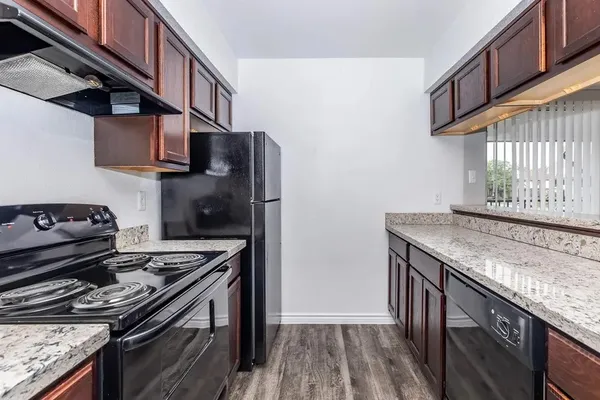 a kitchen with stainless steel appliances granite countertop a stove and a sink