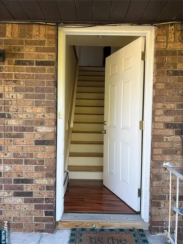 a view of front door of house with stairs