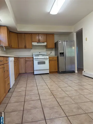 a kitchen with a sink a stove top oven and cabinets