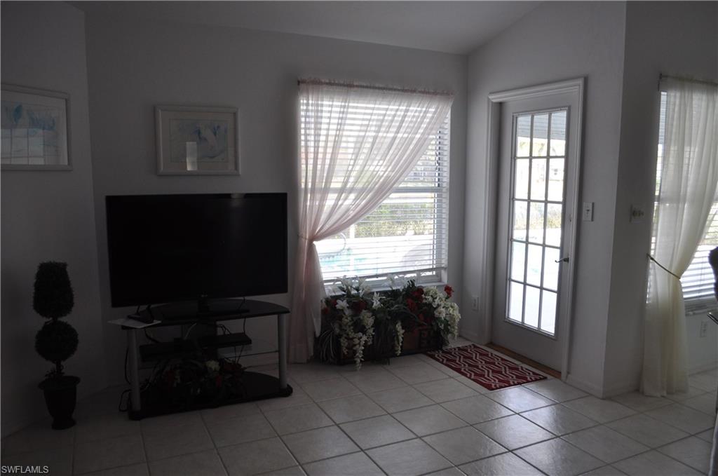 431 Dundee Court Naples, FL 34104 - Photo 11 of 20 a living room with furniture and a flat screen tv