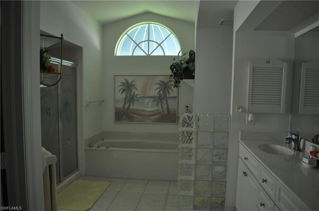 431 Dundee Court Naples, FL 34104 - Photo 13 of 20 a bathroom with a sink a toilet and shower