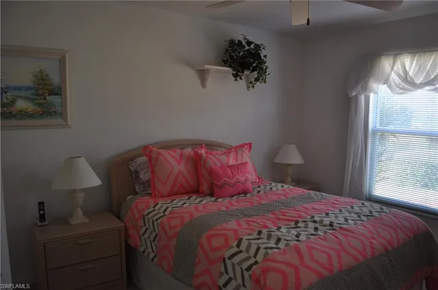 a bed sitting in a bedroom next to a window