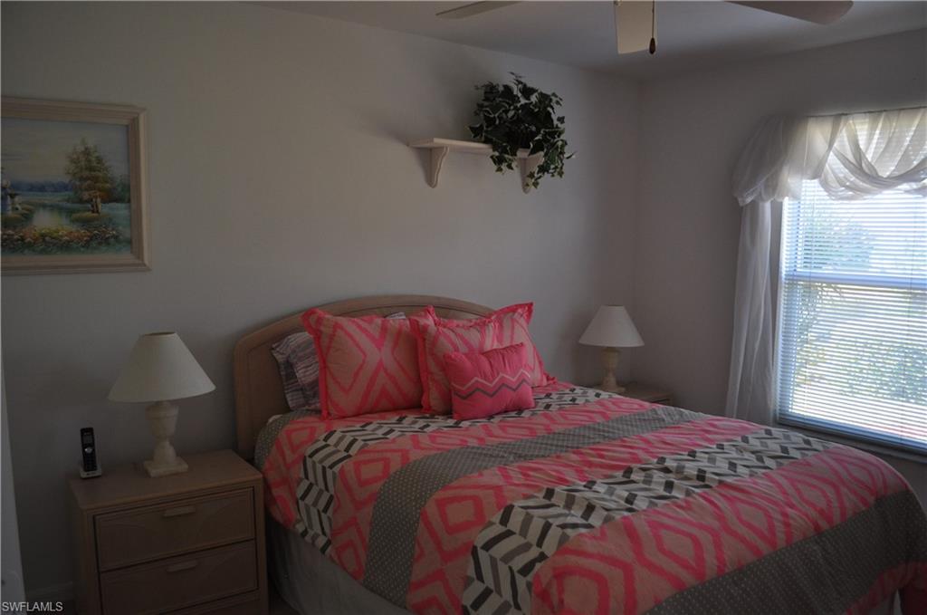 431 Dundee Court Naples, FL 34104 - Photo 15 of 20 a bed sitting in a bedroom next to a window