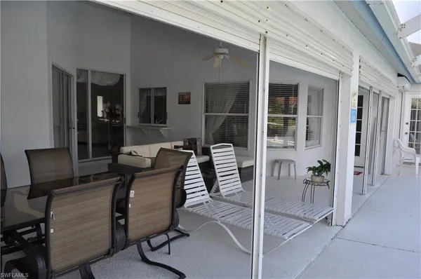 a balcony with table and chairs