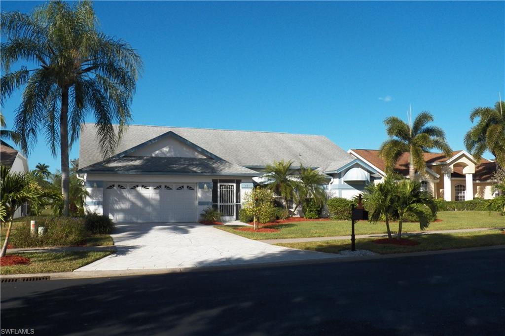 431 Dundee Court Naples, FL 34104 - Photo 2 of 20 a front view of a house with a yard