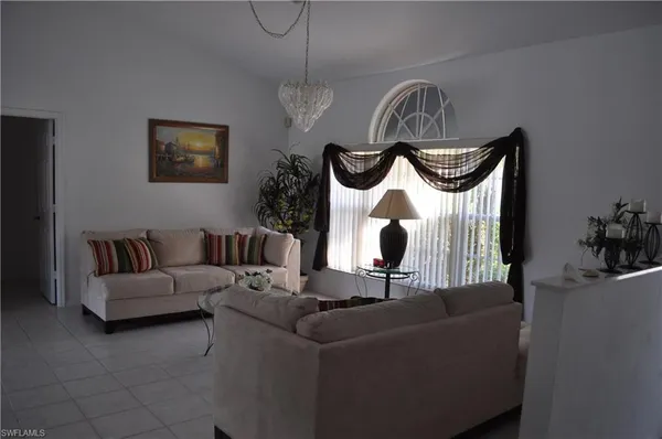 a living room with furniture and a mirror