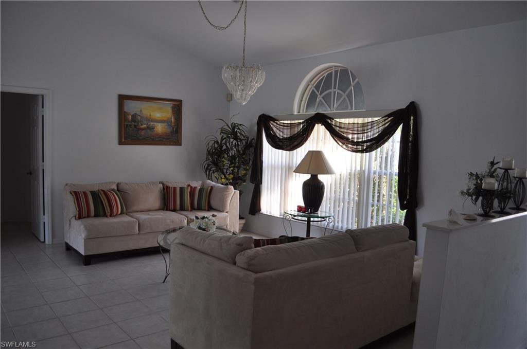 431 Dundee Court Naples, FL 34104 - Photo 4 of 20 a living room with furniture and a mirror