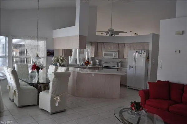 a dining room with furniture a window and kitchen view