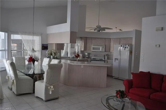 a dining room with furniture a window and kitchen view