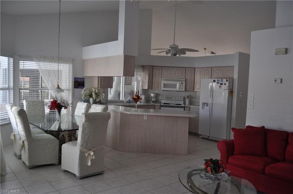431 Dundee Court Naples, FL 34104 - Photo 9 of 20 a dining room with furniture a window and kitchen view