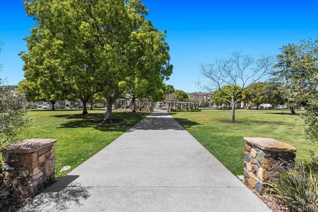 a front view of a building with cars parked