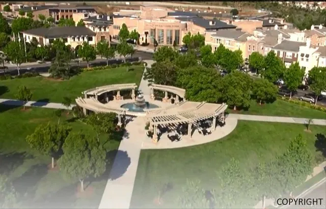 a front view of a house with garden and plants