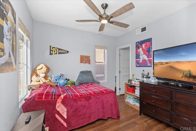 a view of a dining room with furniture a kitchen and chandelier