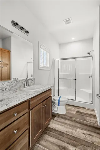 a spacious bathroom with a granite countertop sink and a mirror