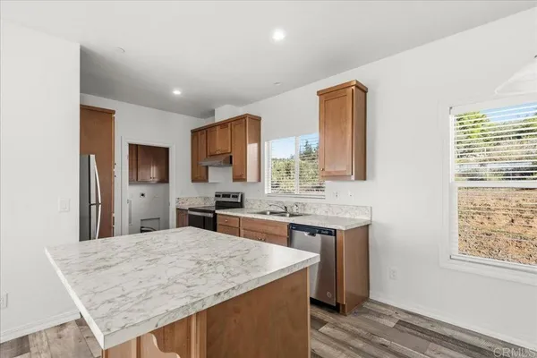a spacious bathroom with a granite countertop sink and a mirror