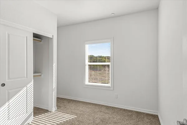 a view of a room with wooden floor and closet