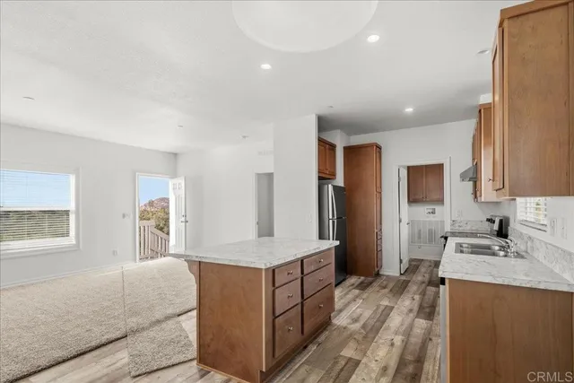 a spacious bathroom with a granite countertop sink and a mirror