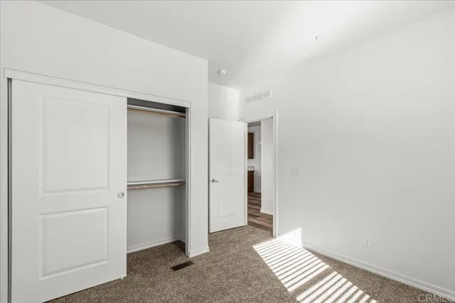 a view of a room with wooden floor and closet