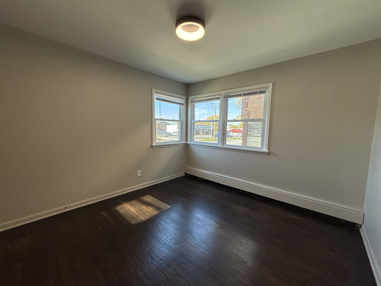 17909 Torrence Avenue, Unit 3 Lansing, IL 60438 - Photo 7 of 9 an empty room with wooden floor and windows