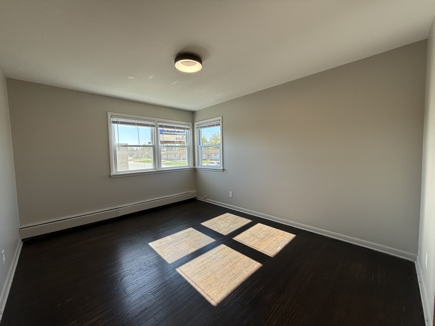 17909 Torrence Avenue, Unit 3 Lansing, IL 60438 - Photo 9 of 9 an empty room with wooden floor and windows