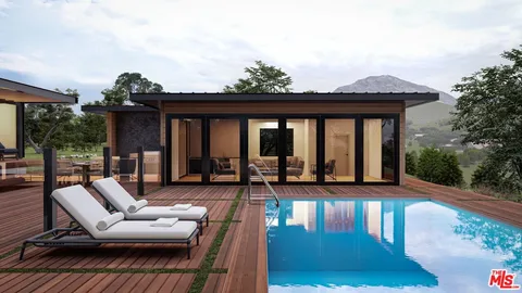 a view of a patio with couches and dining table with wooden floor