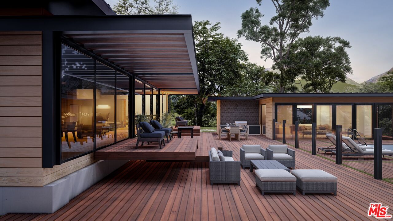 6672 Zumirez Drive Malibu, CA 90265 - Photo 6 of 32 a view of a patio with couches and dining table with wooden floor