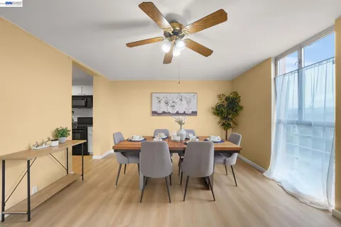 a view of a dining room with furniture and a chandelier