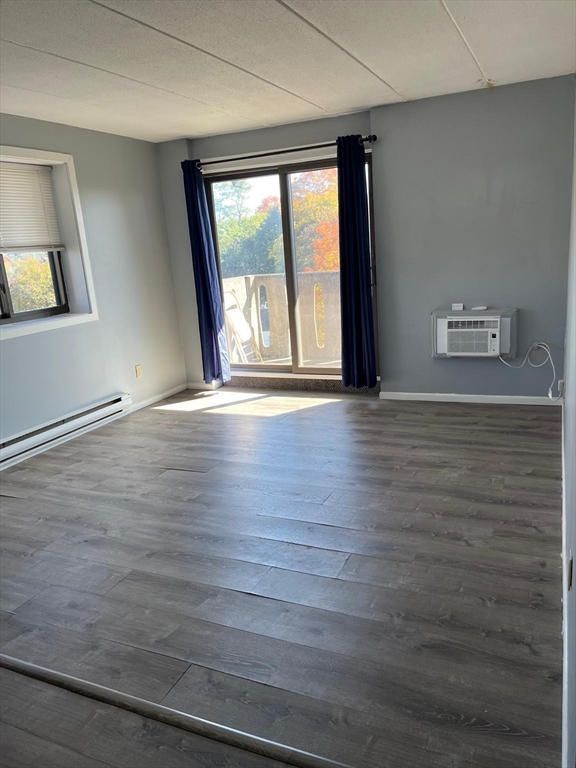 10 Main Street, Unit 508 Framingham, MA 01702 - Photo 2 of 11 a view of an empty room with wooden floor and a window