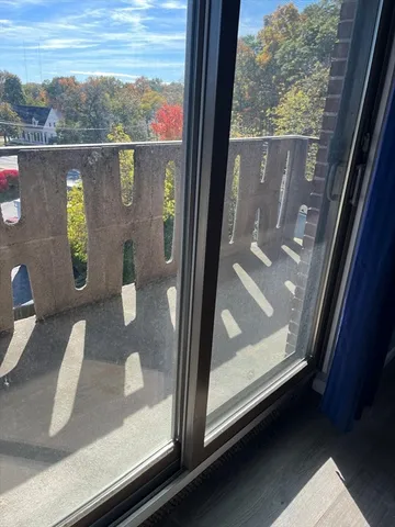 a view of a livingroom with wooden floor and window
